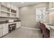 Well-lit office with built-in shelving and a spacious desk perfect for productivity at 12014 Perennial Pl, Lakewood Ranch, FL 34211