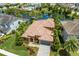 Stunning aerial view of a beautiful house with a tile roof and landscaped yard at 12014 Perennial Pl, Lakewood Ranch, FL 34211