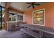 Outdoor kitchen with built-in grill and dining area at 12014 Perennial Pl, Lakewood Ranch, FL 34211