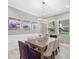 Bright dining room features a wood table with purple and beige chairs at 12014 Perennial Pl, Lakewood Ranch, FL 34211
