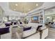 Expansive living room with built-in shelving and a large TV at 12014 Perennial Pl, Lakewood Ranch, FL 34211
