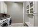 Laundry room with washer, dryer, and built-in storage at 12014 Perennial Pl, Lakewood Ranch, FL 34211