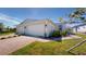 Two-car garage and front yard with landscaping at 16132 Ivy Ridge Ct, Port Charlotte, FL 33953