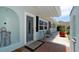 Inviting entryway with a gray door, brick flooring, and a small seating area at 3005 39Th W Ave, Bradenton, FL 34205