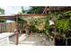 Lush garden with various plants and a pergola at 3005 39Th W Ave, Bradenton, FL 34205