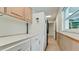 Bright laundry room with white cabinets and a refrigerator at 3005 39Th W Ave, Bradenton, FL 34205