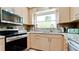 Updated kitchen with light wood cabinets and granite countertops at 3005 39Th W Ave, Bradenton, FL 34205