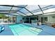Inviting screened pool area with a hot tub and covered patio at 3005 39Th W Ave, Bradenton, FL 34205