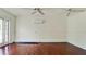 Hardwood floors, ceiling fan, and a wall-mounted air conditioning unit at 3005 39Th W Ave, Bradenton, FL 34205
