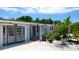Home's exterior showcasing double doors, landscaping, and a fountain next to the entrance at 3005 39Th W Ave, Bradenton, FL 34205