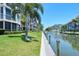 Building with canal-side walkway and boat slips at 1300 N Portofino Dr # 305, Sarasota, FL 34242