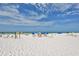 Relaxing beach view with lounge chairs and umbrellas at 1300 N Portofino Dr # 305, Sarasota, FL 34242