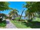 Paved pathway winds through lush landscaping, towards waterfront at 1300 N Portofino Dr # 305, Sarasota, FL 34242