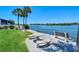 Waterfront seating area with picnic tables and bench at 1300 N Portofino Dr # 305, Sarasota, FL 34242