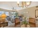Spacious dining area with chandelier and view of living room at 1300 N Portofino Dr # 305, Sarasota, FL 34242