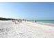 Expansive sandy beach with people enjoying the sun at 1300 N Portofino Dr # 305, Sarasota, FL 34242