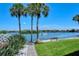 Pathway alongside waterfront with lush landscaping and bench at 1300 N Portofino Dr # 305, Sarasota, FL 34242