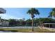 Community tennis court surrounded by palm trees and parking area at 2700 Hidden Lake S Dr # A, Sarasota, FL 34237