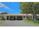 Two-story condo building with a carport and landscaping at 390 301 W Blvd # 1B, Bradenton, FL 34205