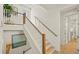 Elegant staircase with wooden handrail and light walls at 404 North Shore Dr, Anna Maria, FL 34216
