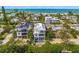 Aerial view of a luxury home near the ocean, showcasing its unique design and prime location at 404 North Shore Dr, Anna Maria, FL 34216