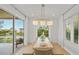 Bright dining room with water views and light wood table at 404 North Shore Dr, Anna Maria, FL 34216