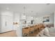 Modern white kitchen with large island and breakfast bar at 404 North Shore Dr, Anna Maria, FL 34216