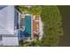 Aerial view of a home with a pristine pool and spacious deck, perfect for relaxation at 404 North Shore Dr, Anna Maria, FL 34216