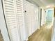 Hallway with built-in storage and wood-look flooring at 5408 Swift Rd # 28, Sarasota, FL 34231