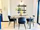 Dining area with a modern table and four black velvet chairs at 5408 Swift Rd # 28, Sarasota, FL 34231