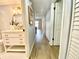 Bright hallway with light grey walls and wood-look flooring at 5408 Swift Rd # 28, Sarasota, FL 34231