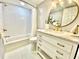Clean bathroom with white subway tile, gold fixtures, and herringbone floor at 5408 Swift Rd # 28, Sarasota, FL 34231