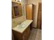 Bathroom featuring vanity with mirror and decorative wallpaper at 407 White Oak Way, Sarasota, FL 34237