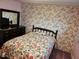 Bedroom featuring floral wallpaper, dark dresser and an accent mirror at 407 White Oak Way, Sarasota, FL 34237