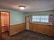 Cozy bedroom with carpet, wood-paneling and closet with shelf organization at 407 White Oak Way, Sarasota, FL 34237