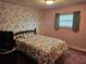 Cozy bedroom featuring floral wallpaper and window with blinds at 407 White Oak Way, Sarasota, FL 34237