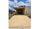 Long driveway leading to a covered parking area, complemented by the home's neat exterior at 407 White Oak Way, Sarasota, FL 34237