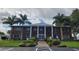Beautiful two-story brick building entrance with white pillars, mature landscaping, and accessible parking at 407 White Oak Way, Sarasota, FL 34237