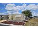 Cozy home exterior with a landscaped yard, manicured flower beds, and a well-maintained facade at 407 White Oak Way, Sarasota, FL 34237