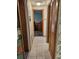Hallway with a tiled floor and a view into an office area at 407 White Oak Way, Sarasota, FL 34237