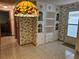 Bright hallway with a tiled floor and decorative wallpaper and a built-in wall cabinet at 407 White Oak Way, Sarasota, FL 34237
