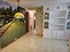 Bright hallway with a tiled floor, wallpaper, and a large mural accenting the space at 407 White Oak Way, Sarasota, FL 34237