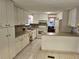 Well-lit kitchen with white cabinets, neutral countertops, and modern appliances at 407 White Oak Way, Sarasota, FL 34237