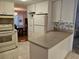 Bright kitchen with white appliances, ample cabinetry, and adjacent dining area at 407 White Oak Way, Sarasota, FL 34237