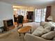Comfortable living room with carpeted floors, a sliding glass door, and vintage furniture at 407 White Oak Way, Sarasota, FL 34237