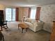 Comfortable living room with carpeted floors, sliding glass door, and vintage furniture at 407 White Oak Way, Sarasota, FL 34237