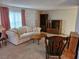 Cozy living room with a comfortable couch, classic furniture, and patterned walls at 407 White Oak Way, Sarasota, FL 34237