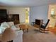 Living room featuring neutral carpet and views into the kitchen at 407 White Oak Way, Sarasota, FL 34237