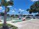 Fun mini golf course featuring colorful obstacles, a scenic pond, and lush landscaping for outdoor recreation at 407 White Oak Way, Sarasota, FL 34237