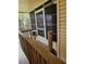 Screened in porch with wooden railing at 407 White Oak Way, Sarasota, FL 34237